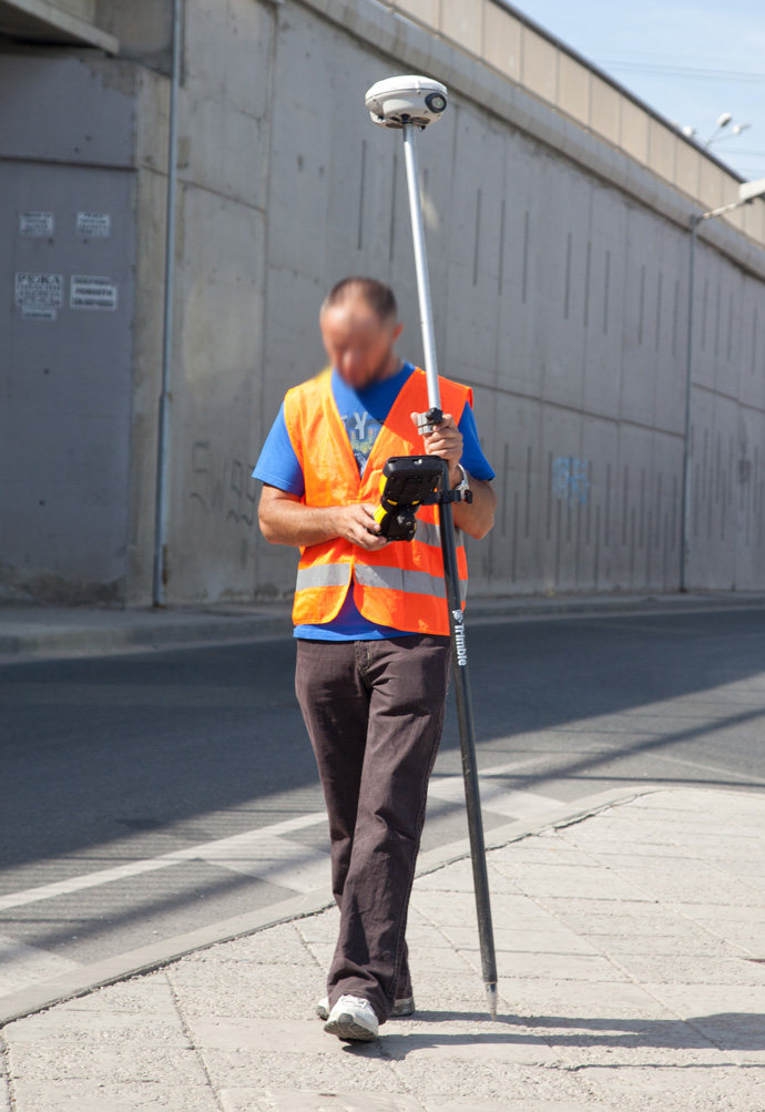 Field worker carrying Trimble gear.